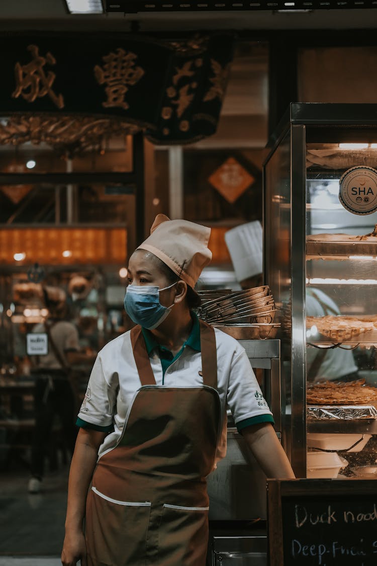 Bakery Employee In Mask And Apron