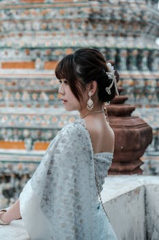 Beautiful Asian woman in traditional clothing at a temple in Bangkok, Thailand.