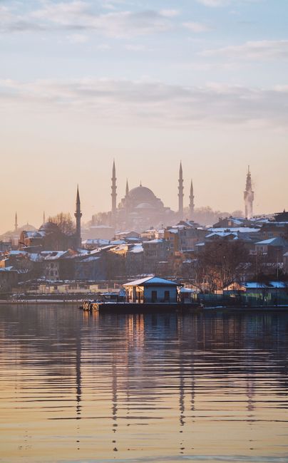 A serene winter scene showcasing Istanbul's iconic skyline and architectural landmarks at sunrise.