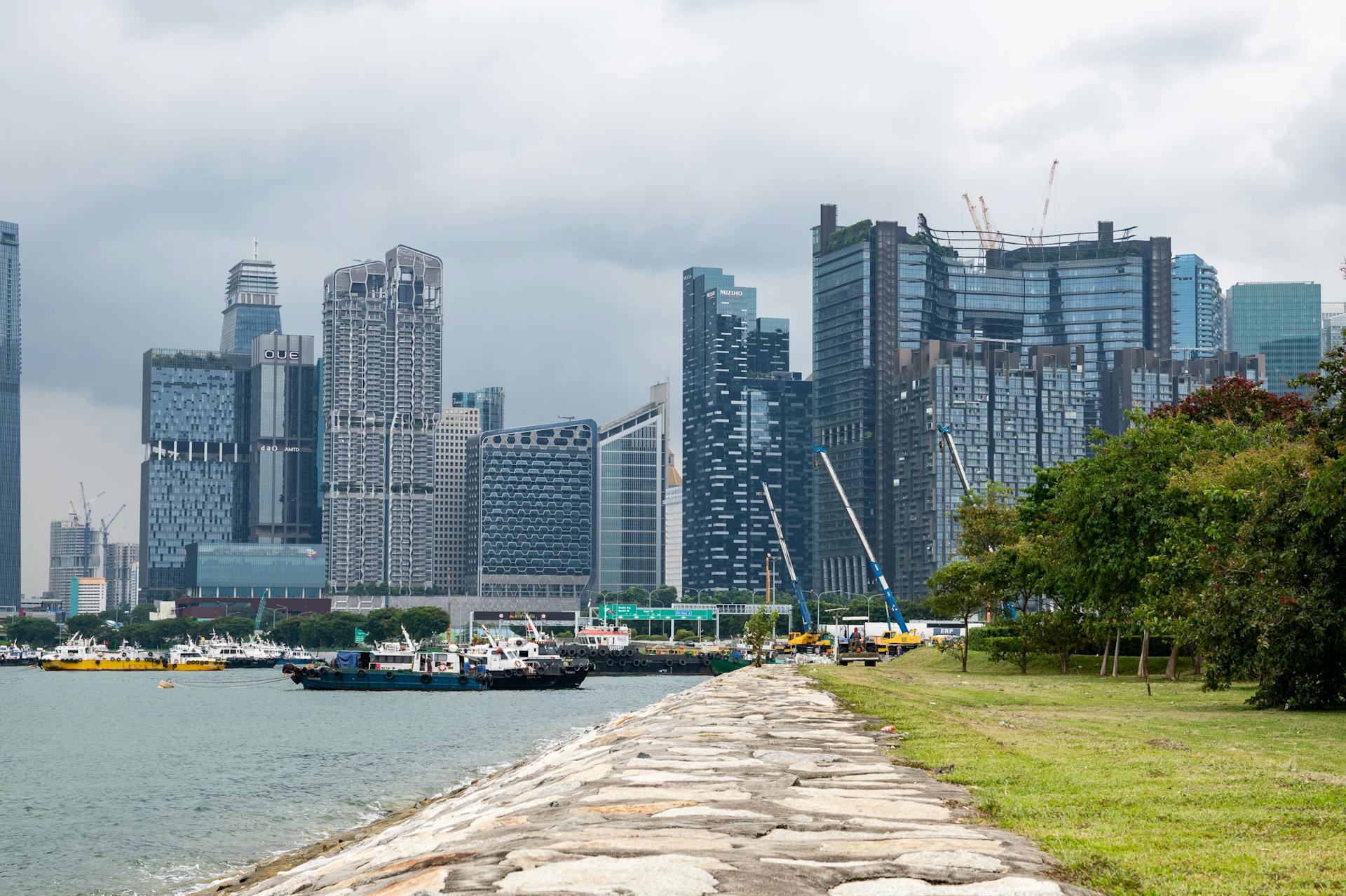 Skyline view of Singapore with modern skyscrapers along the waterfront, showcasing urban development.