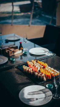 A beautifully arranged sushi platter on a table set in a stylish restaurant, creating an inviting dining atmosphere.