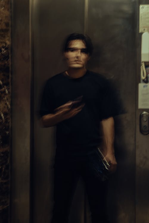 Young Man Standing by Elevator