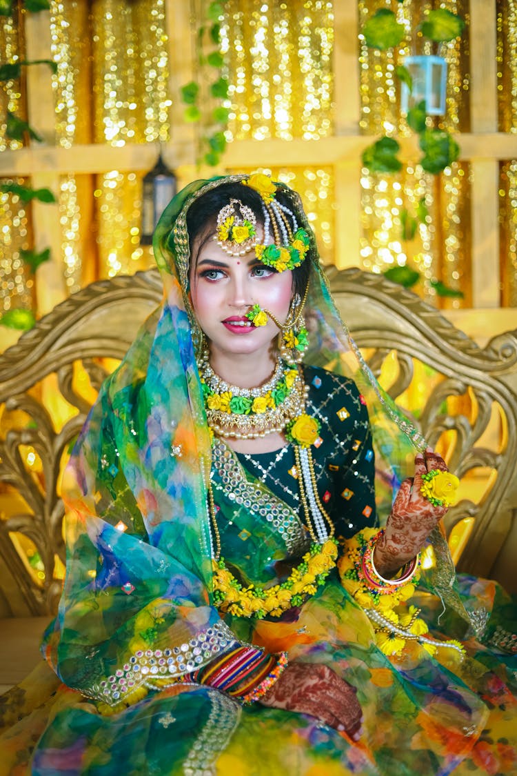 Young Woman In Traditional Indian Wedding Dress Sitting On A Luxury Chair