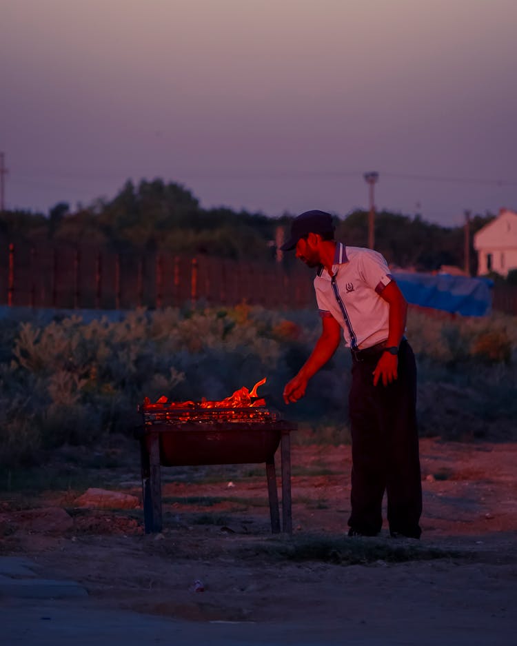 Man Roasting On Barbecue