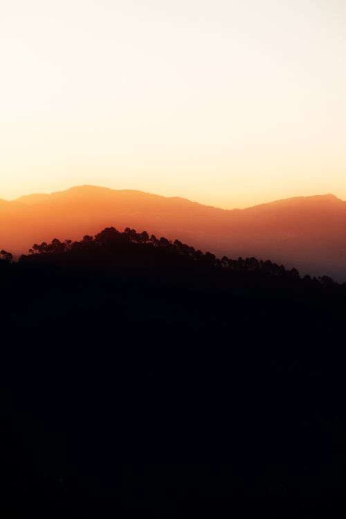 Free A captivating silhouette of Shimla's hills at sunset, showcasing a vibrant yellow sky. Stock Photo