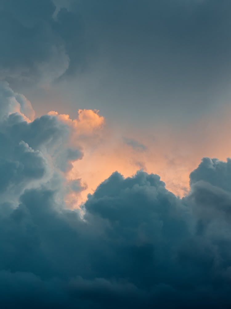 Dramatic Blue Clouds Backlit By Setting Sun