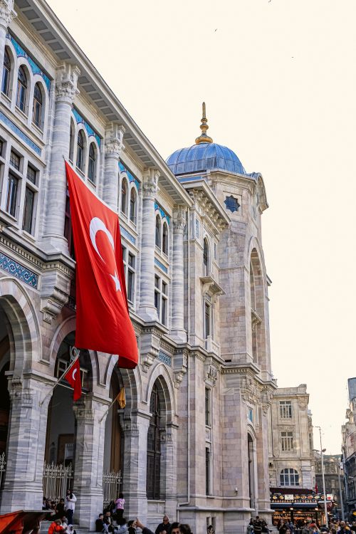 Free The historic Grand Post Office in Istanbul showcases its majestic architecture with a prominent Turkish flag. Stock Photo