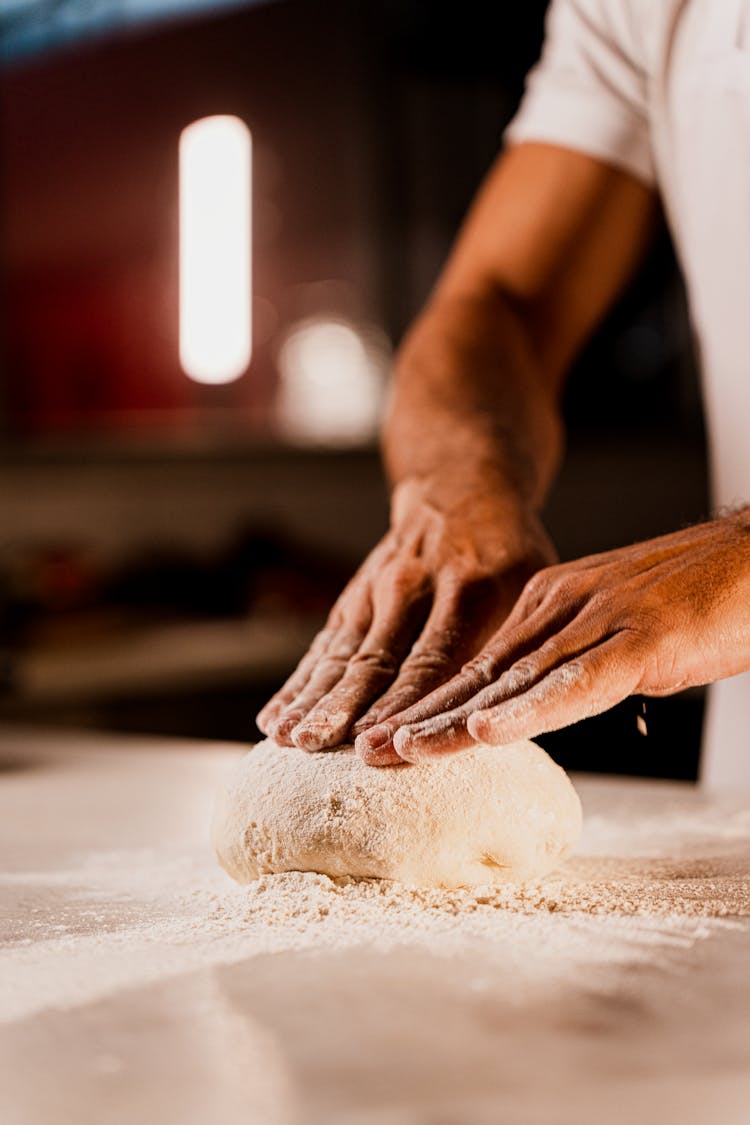 Close Up Of Man Hands On Dough