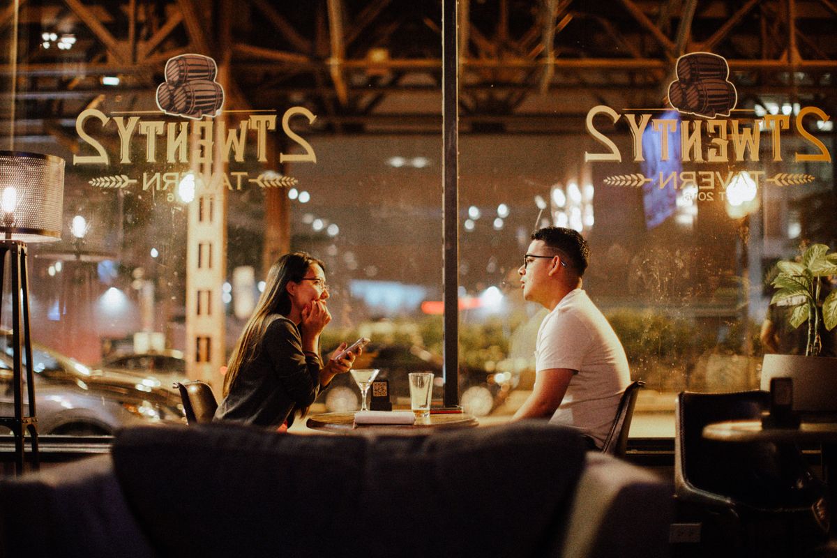 Adults having a private conversation in a refined public setting