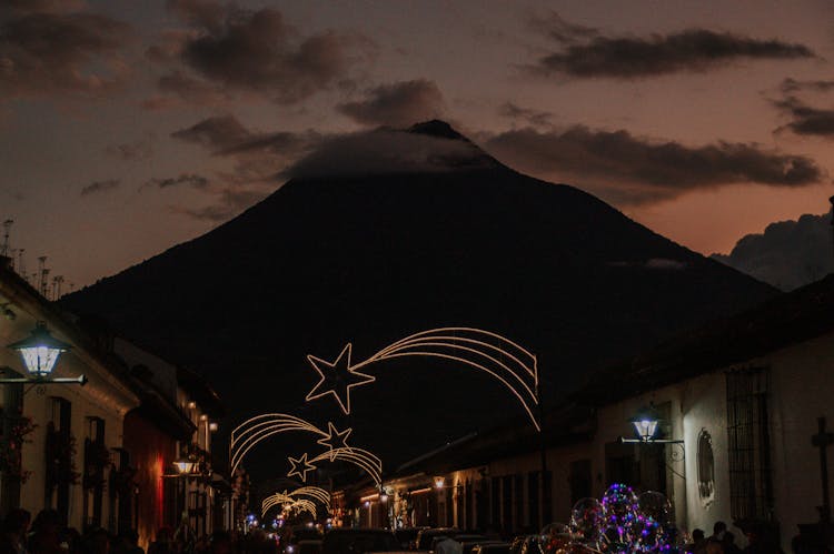 Volcano Silhouette Over Town With Christmas Decoration 