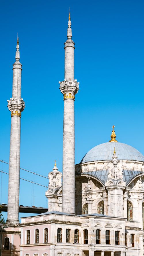 Free Beautiful mosque with tall minarets set against a clear blue sky, highlighting Islamic architecture. Stock Photo