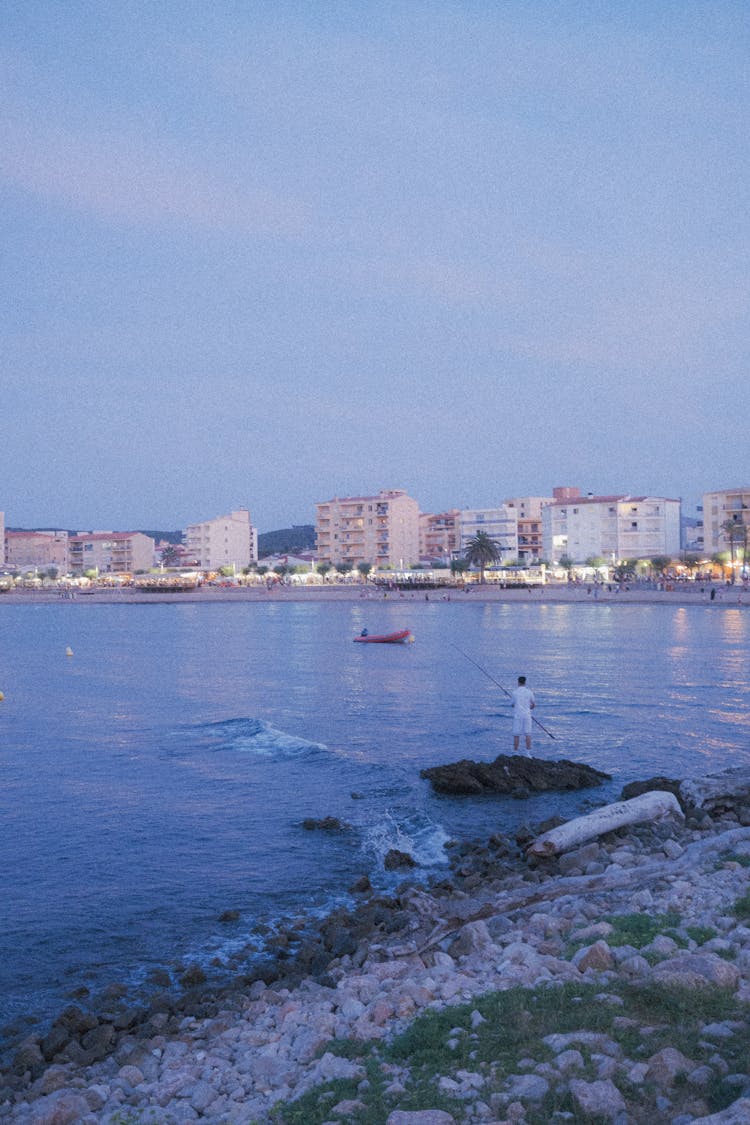 Man Fishing By The Water 