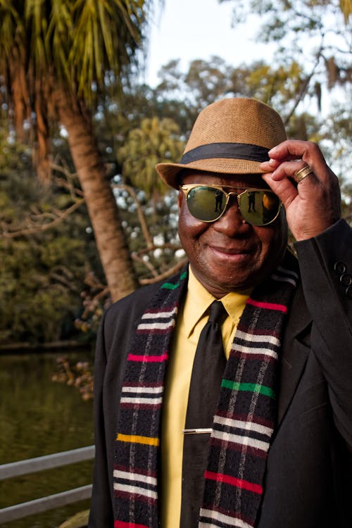 Smiling Man Wearing a Hat and Sunglasses 