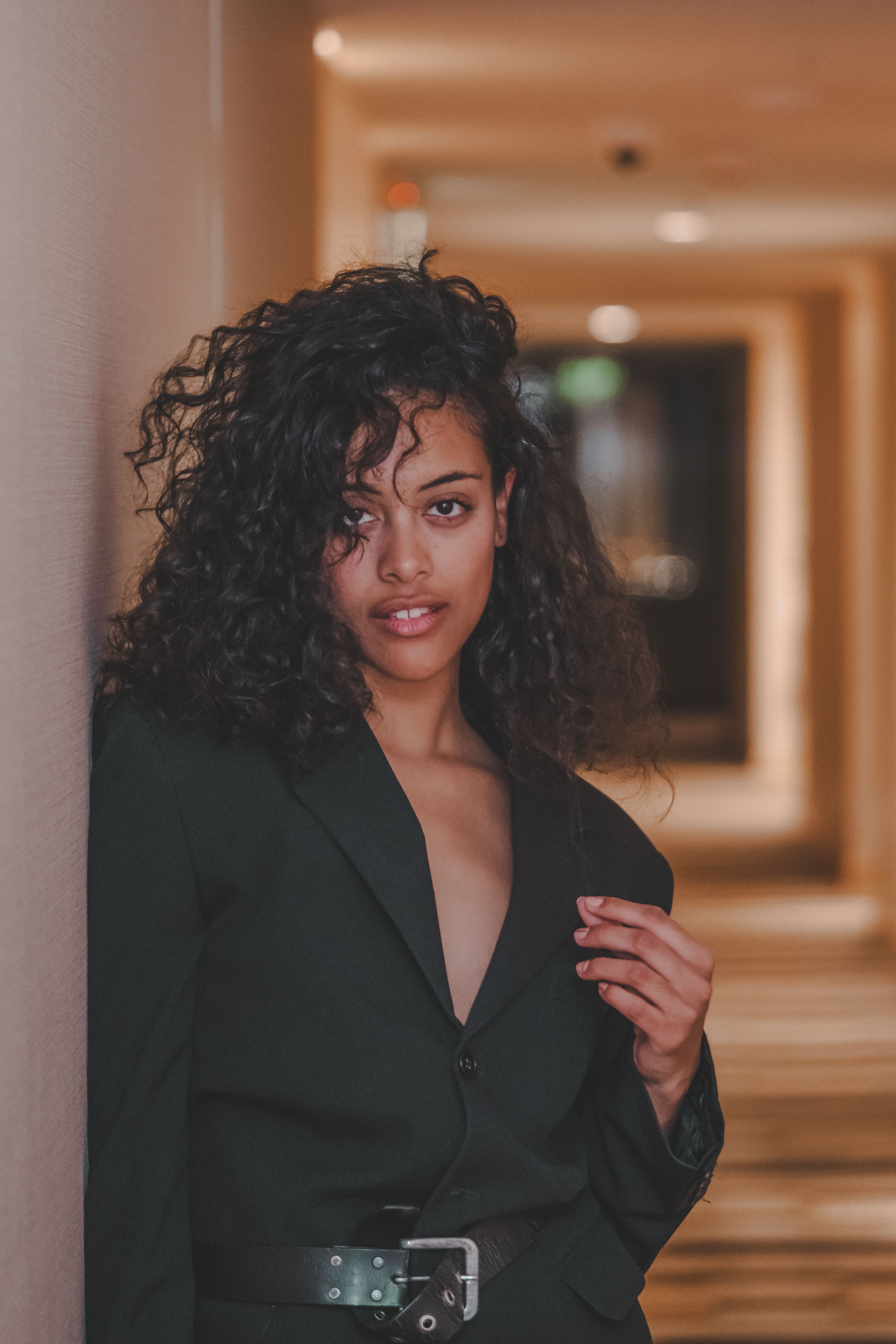 Woman with Long Curly Hair in a Suit Jacket · Free Stock Photo