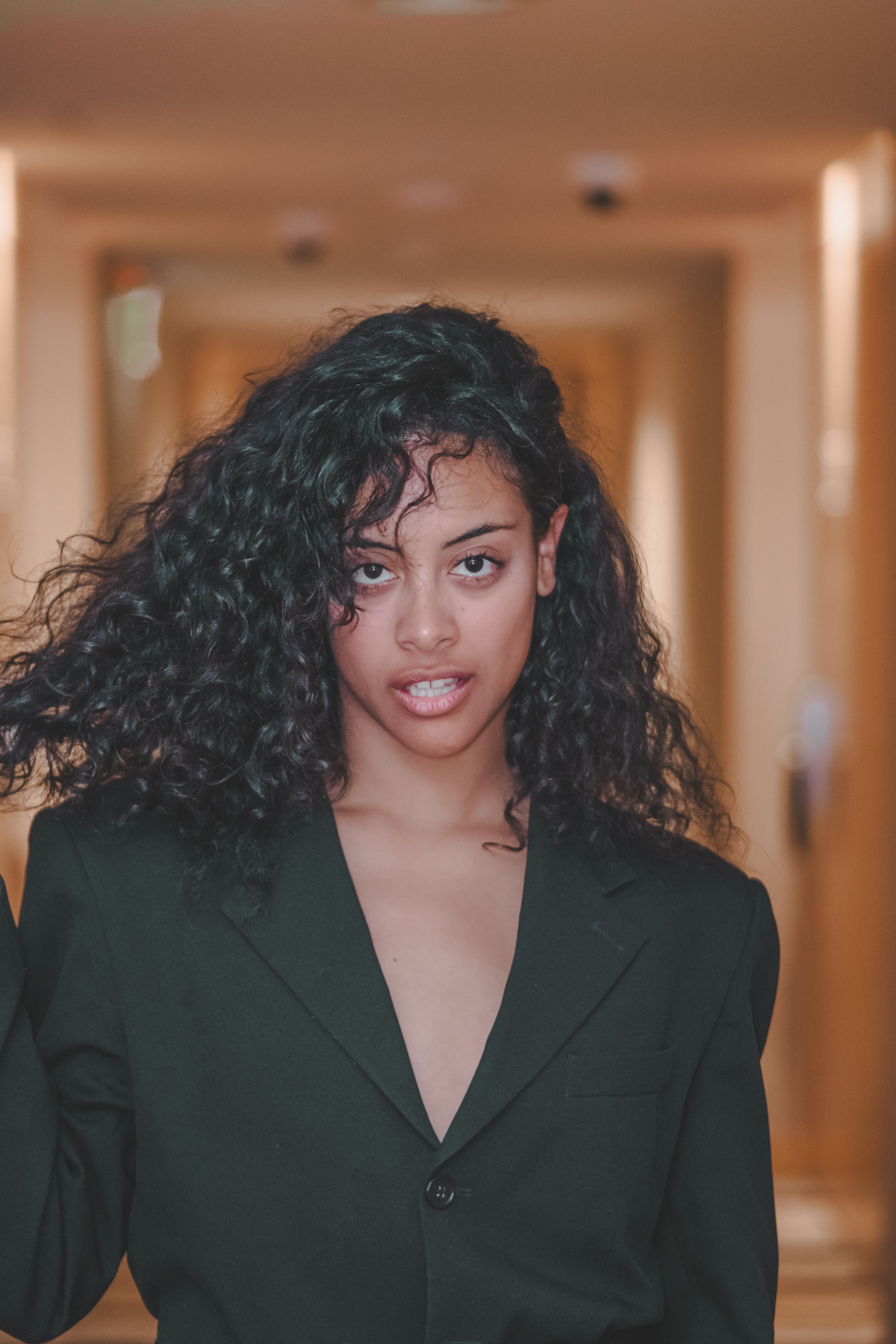 Elegant portrait of a young woman in a sleek jacket, showcasing modern fashion.