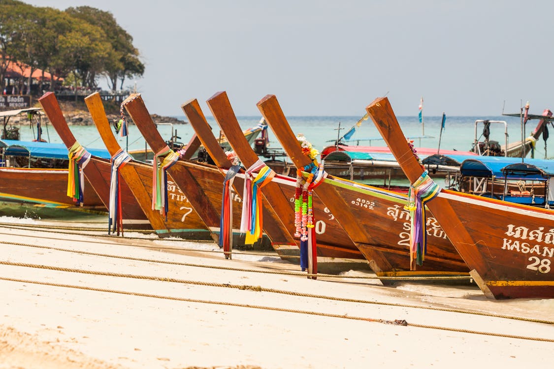 Free Brown Wooden Docked Boat at Daytime Stock Photo