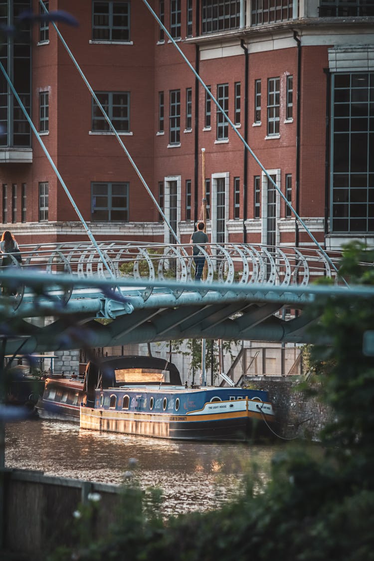 Photo Of A Ship Under The Bridge 