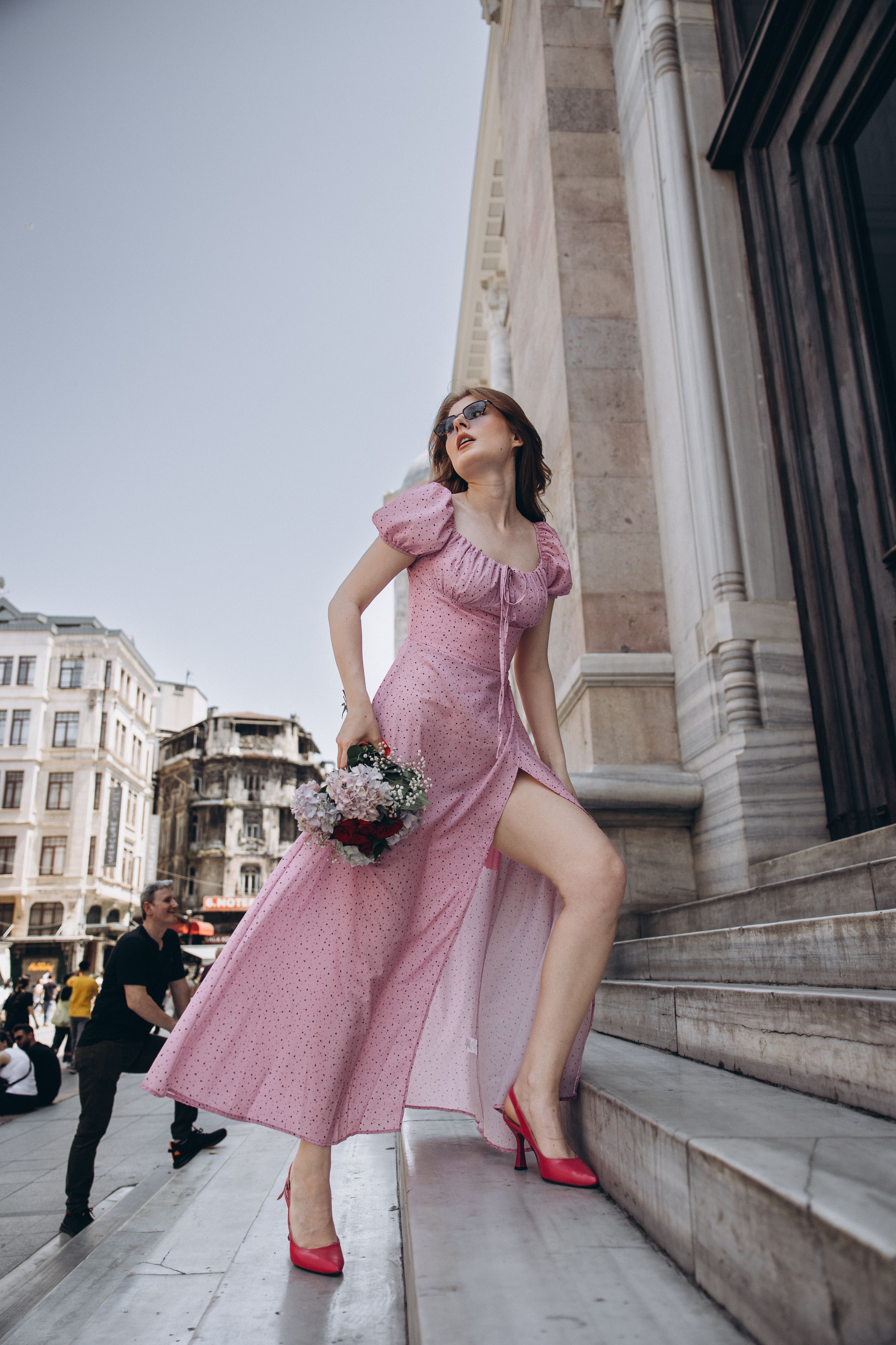 Woman wearing a floral maxi dress with a thigh slit