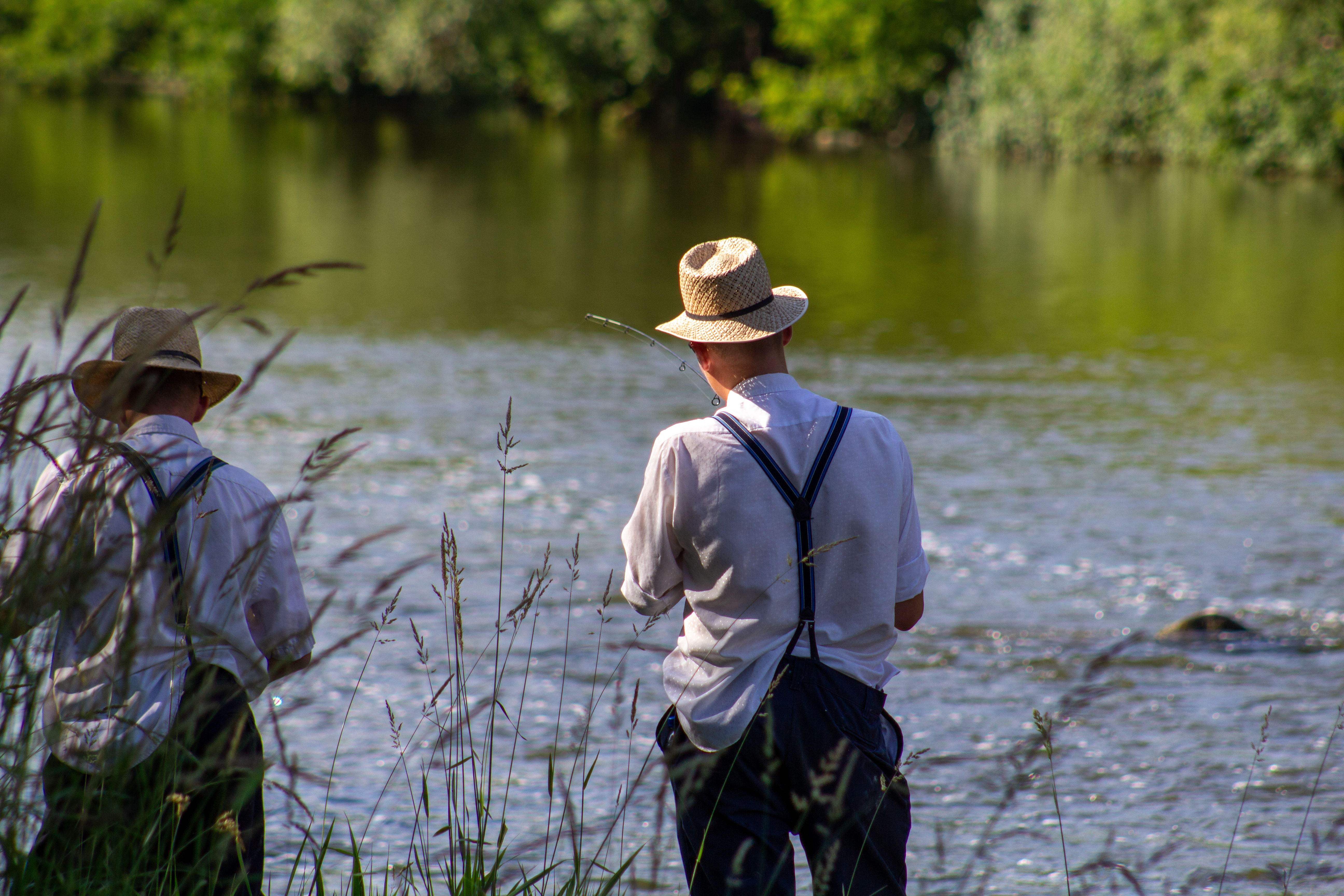 Anglers Fishing From the Riverbank