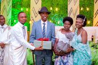 A family gathering celebrates with joyful gift exchange, smiles, and togetherness.