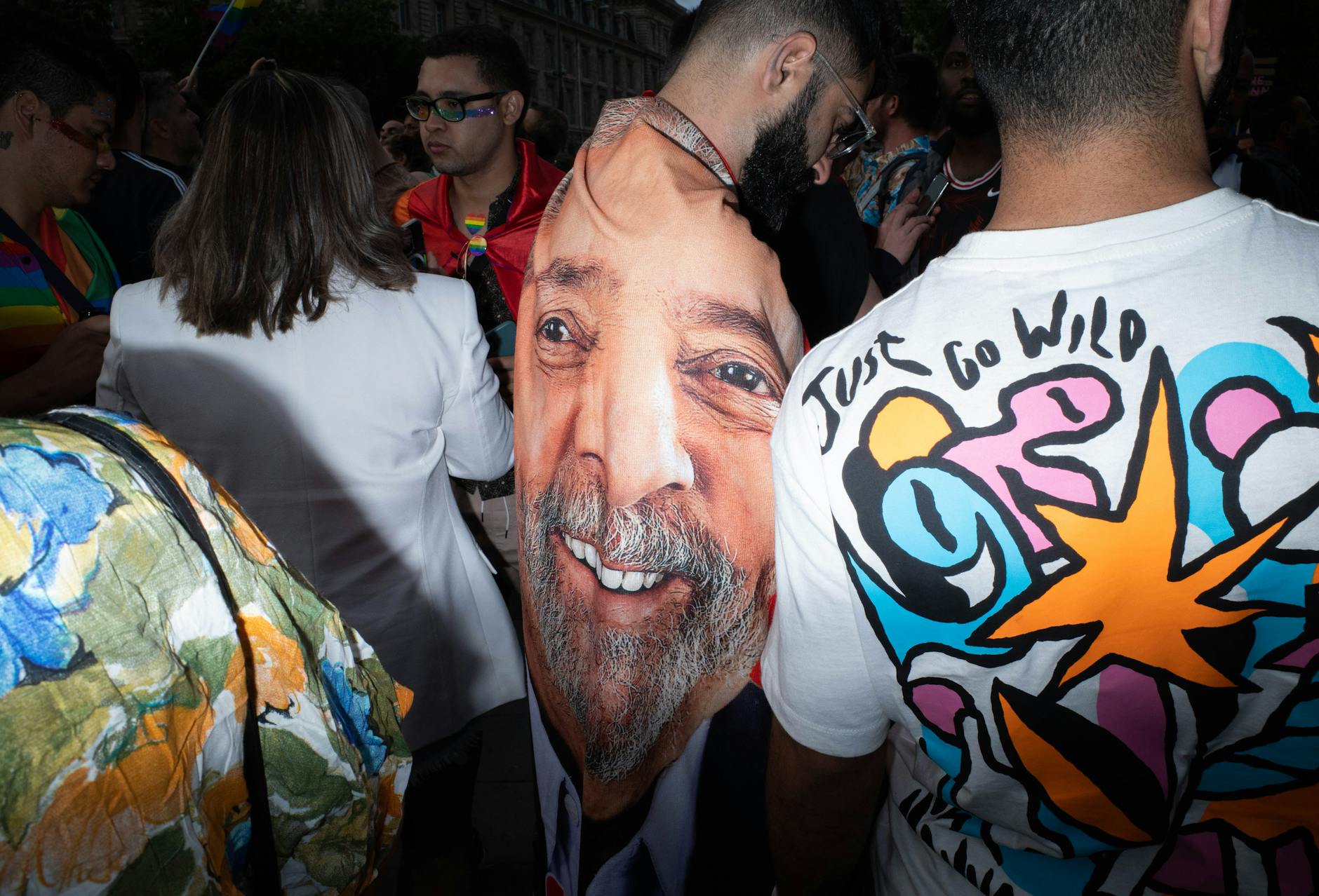 A lively urban scene featuring colorful fashion and artistic expressions at a parade.