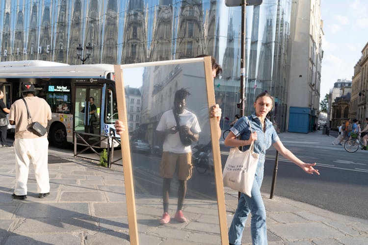 Man Reflecting In Mirror On Street