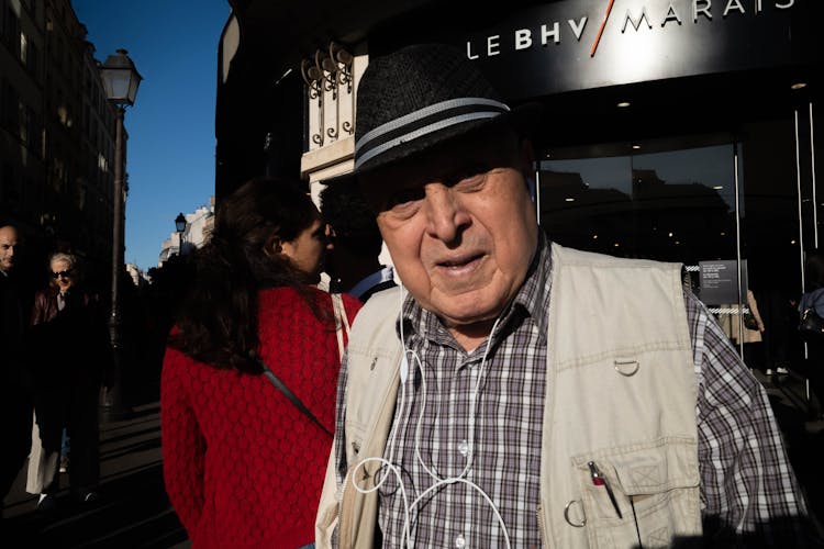 Old Man In Hat In Crowd On City Street