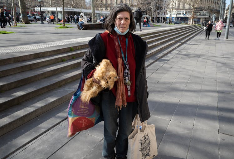 Old Woman With Cat On City Square