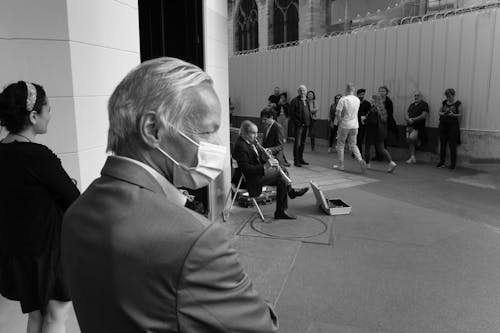 Old Man Playing on Musical Instrument on City Street