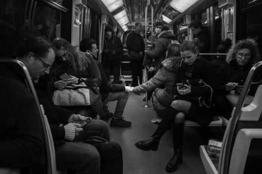 People Sitting on Benches in Overcrowded Train