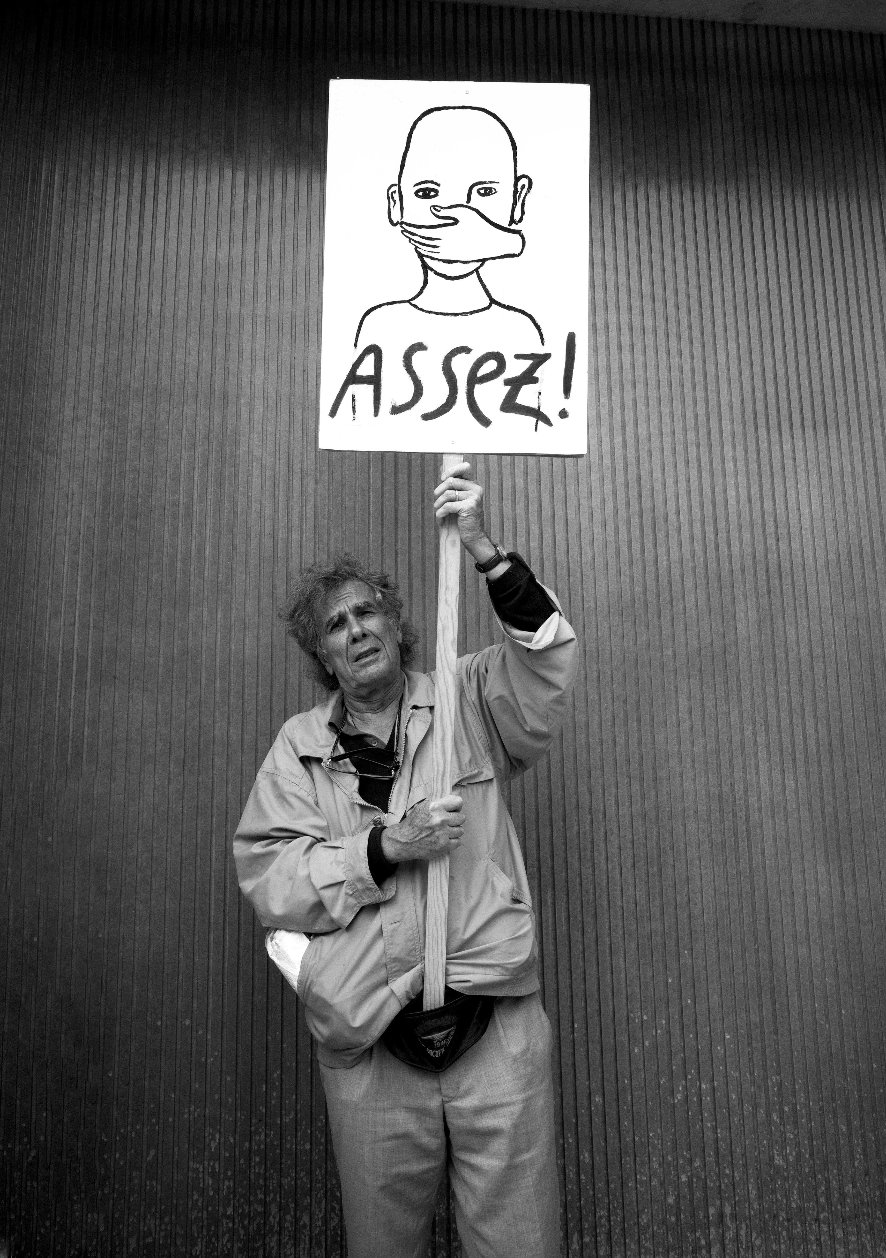 a man holding a banner at a protest