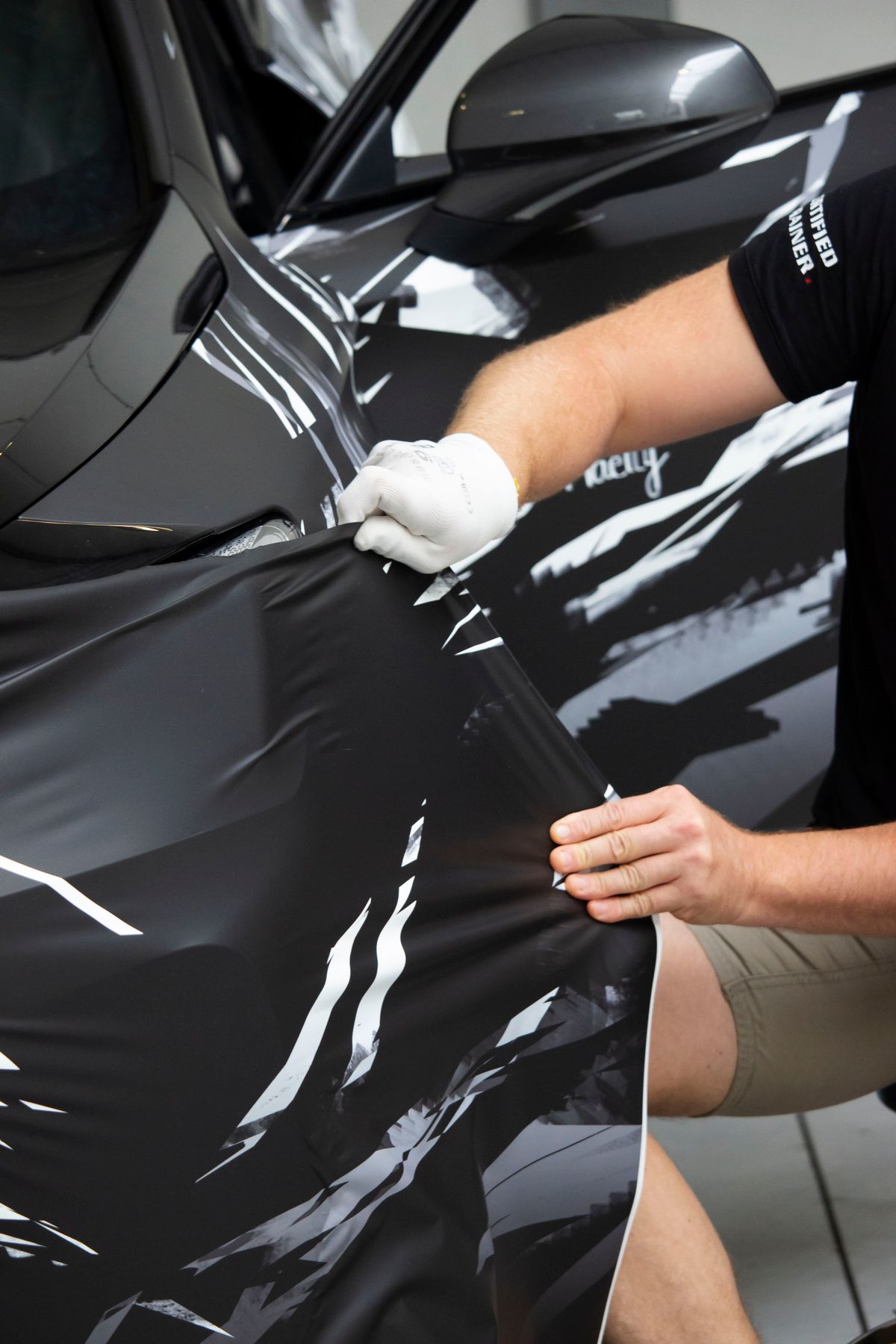 Vinyl vehicle wrap being professionally installed