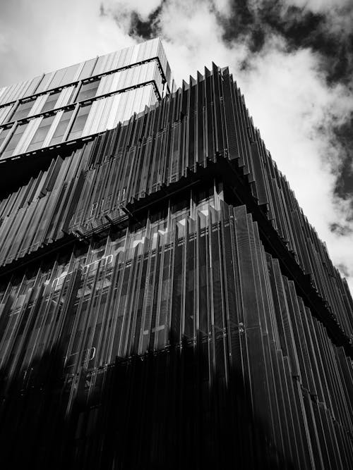 Modern Geometric Building against Cloudy Sky