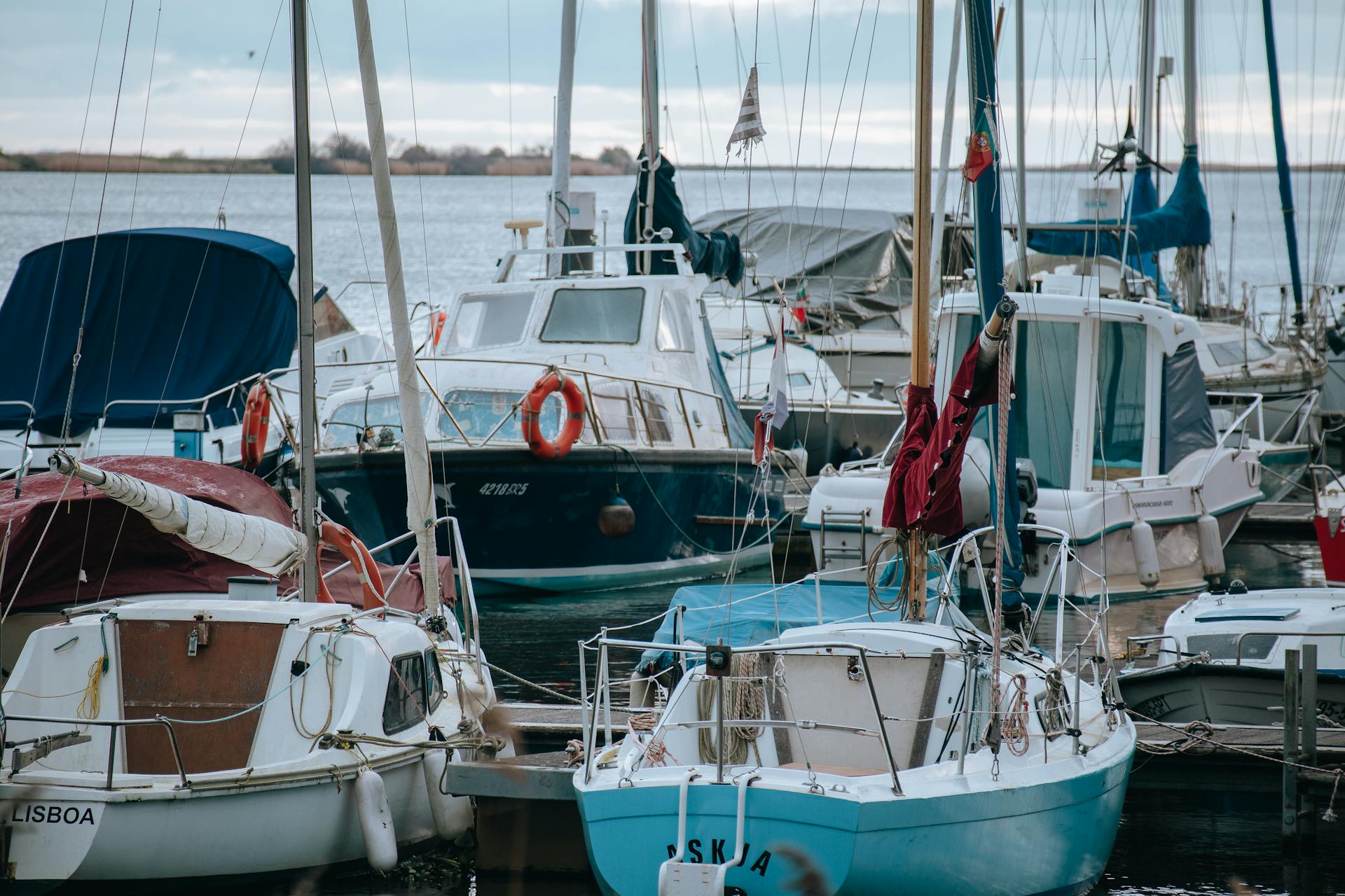 A peaceful view of sailboats moored in a Lisbon marina, capturing the essence of nautical life.