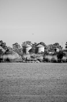Monochrome view of Lisbon's riverbank with industrial silos.