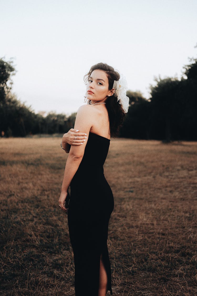 Young Brunette Woman Posing In Black Bandeau Maxi Dress