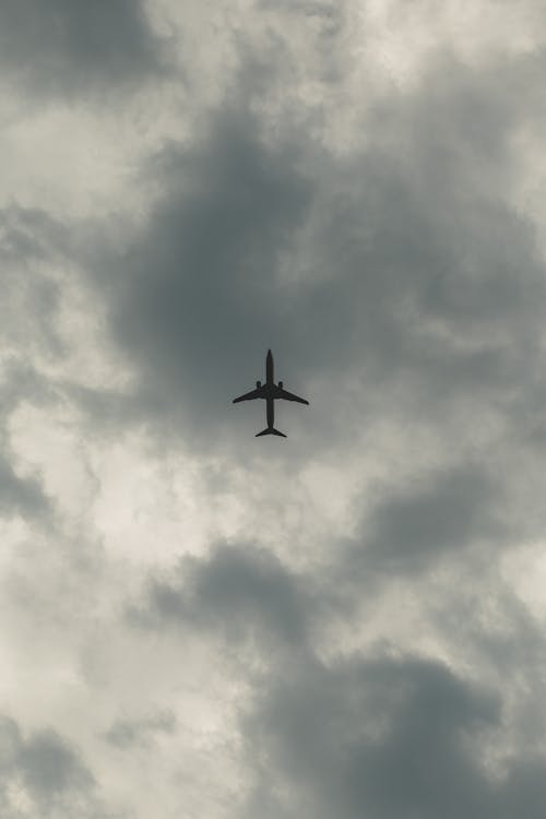 Plane Flying in Cloudy Sky