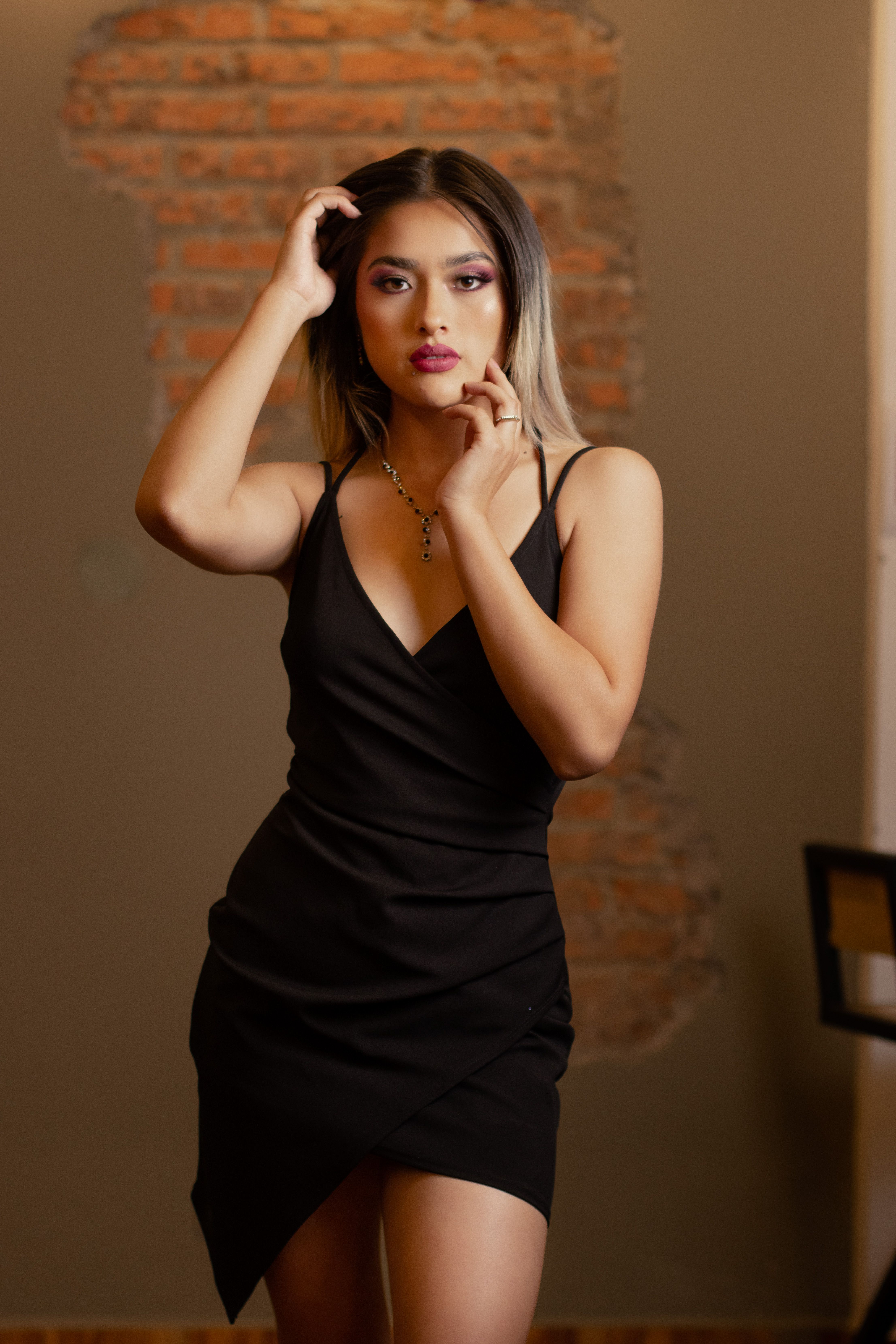Woman in a Black Dress Posing · Free Stock Photo