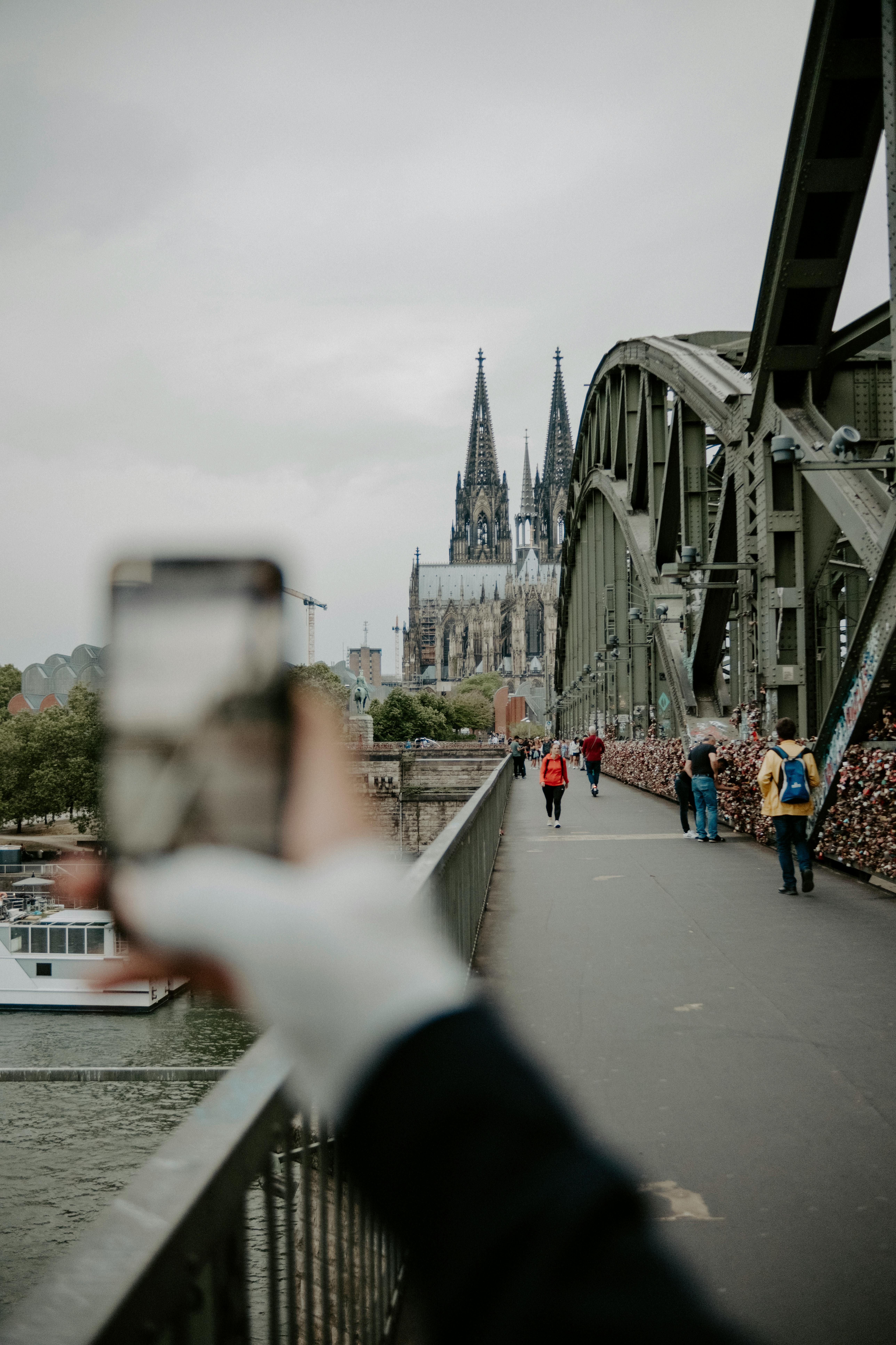 person taking a picture of the cologne cathedral from a distance