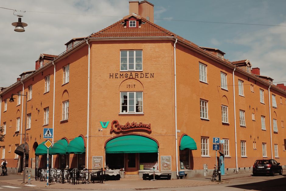 Sunlit brick building at a street corner in Jönköping, Sweden with historical architecture.