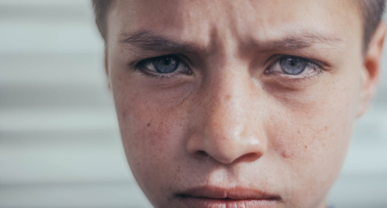 Close-up Photo of Sad Boy's Face