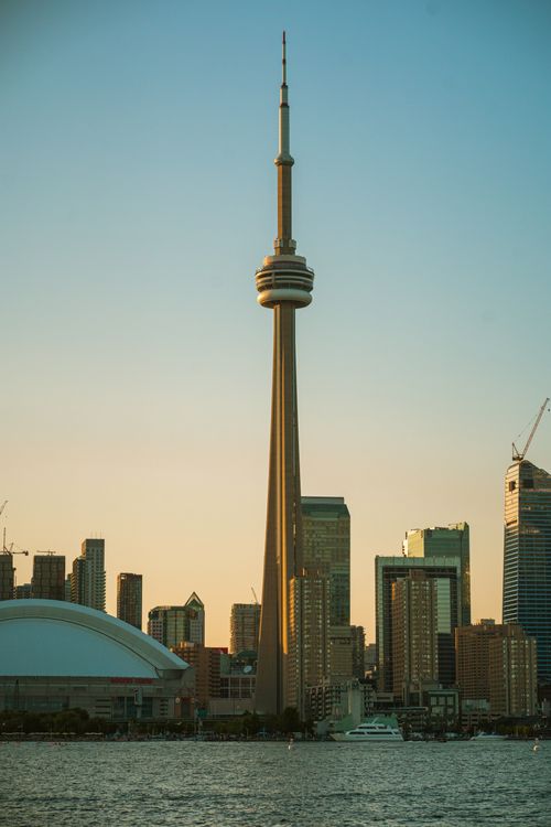 Free Capture of Toronto skyline featuring the CN Tower and cityscape during sunset. Stock Photo