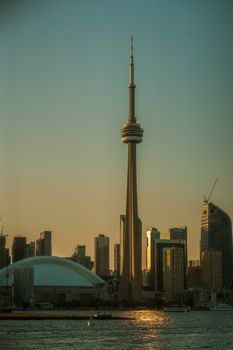 Breathtaking view of Toronto skyline featuring the iconic CN Tower during sunset.