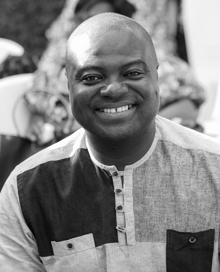 Black And White Portrait Of A Smiling Bald Man 