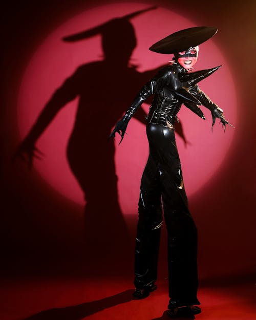 Woman Posing in Black, Leather Costume and in Mask