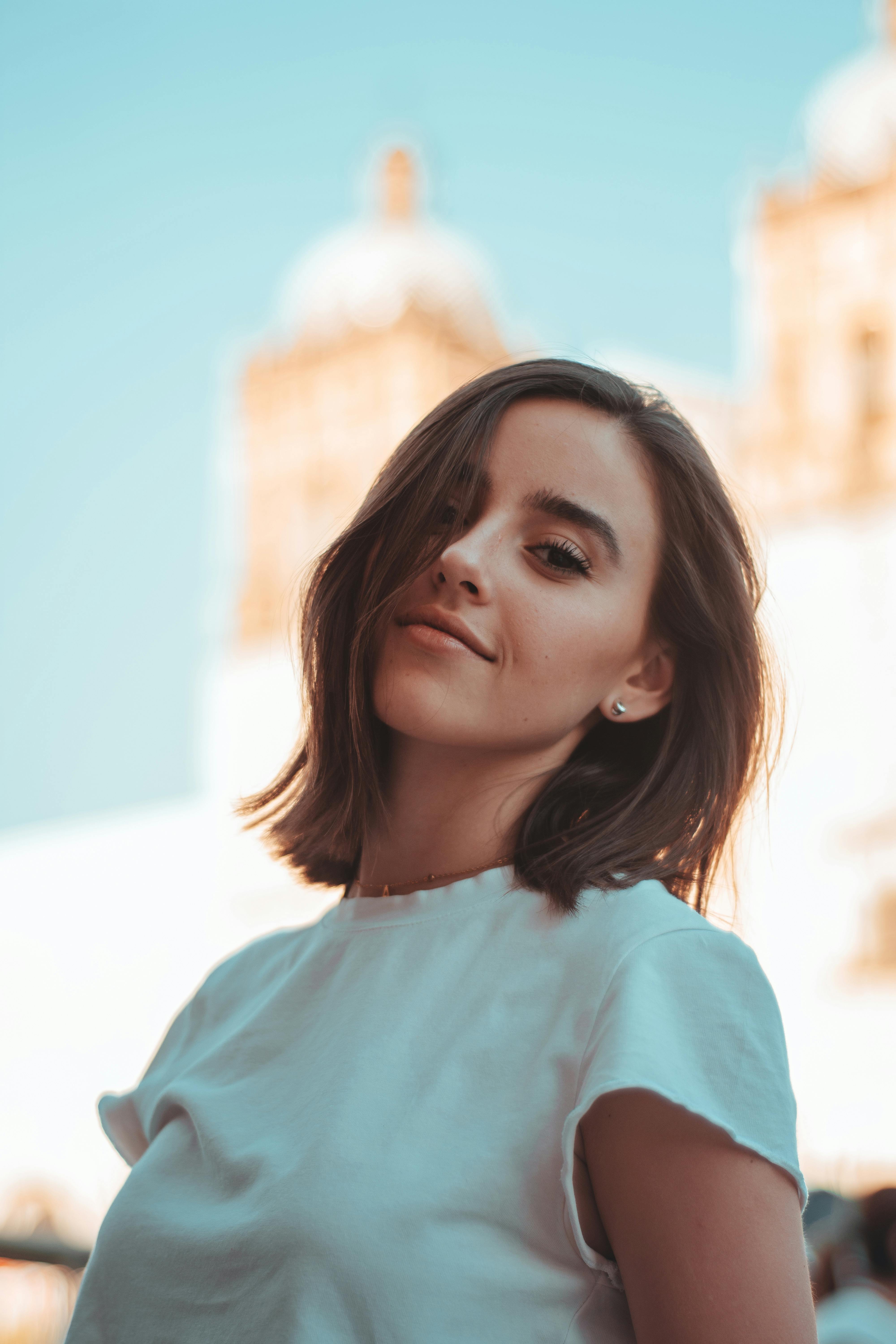 Portrait of a young woman with short hair smiling on a sunny day in Oaxaca, Mexico.