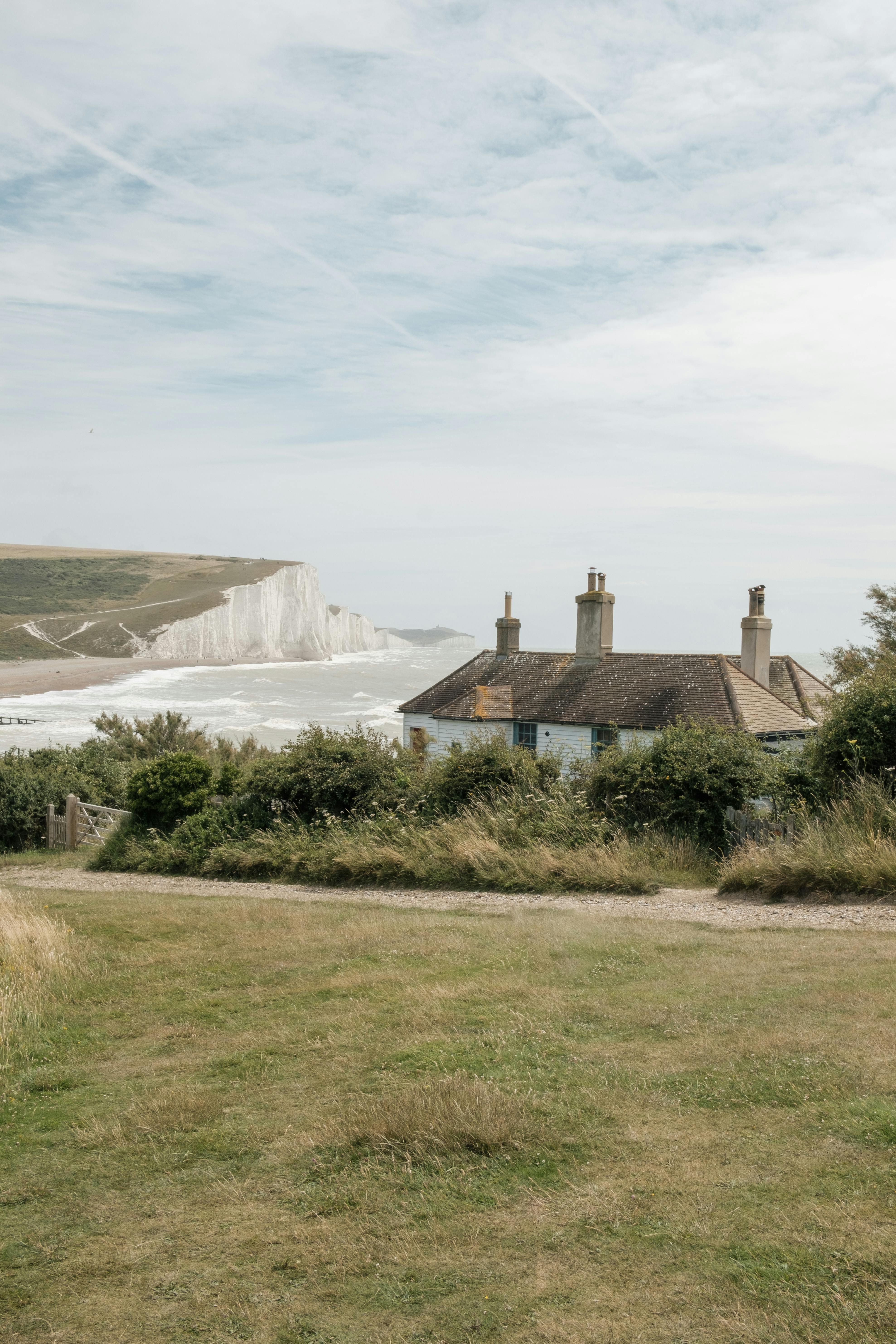 Tranquil rural landscape with cottages and white cliffs at Cuckmere Haven, England.
