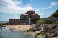 Scenic view of Prieure Saint-Nicolas church by the beach in France, under a blue sky.