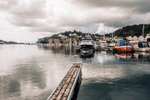 Shore with Moored Motorboats in Town