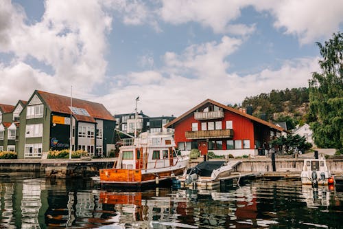 Motorboats Moored near Houses in Town